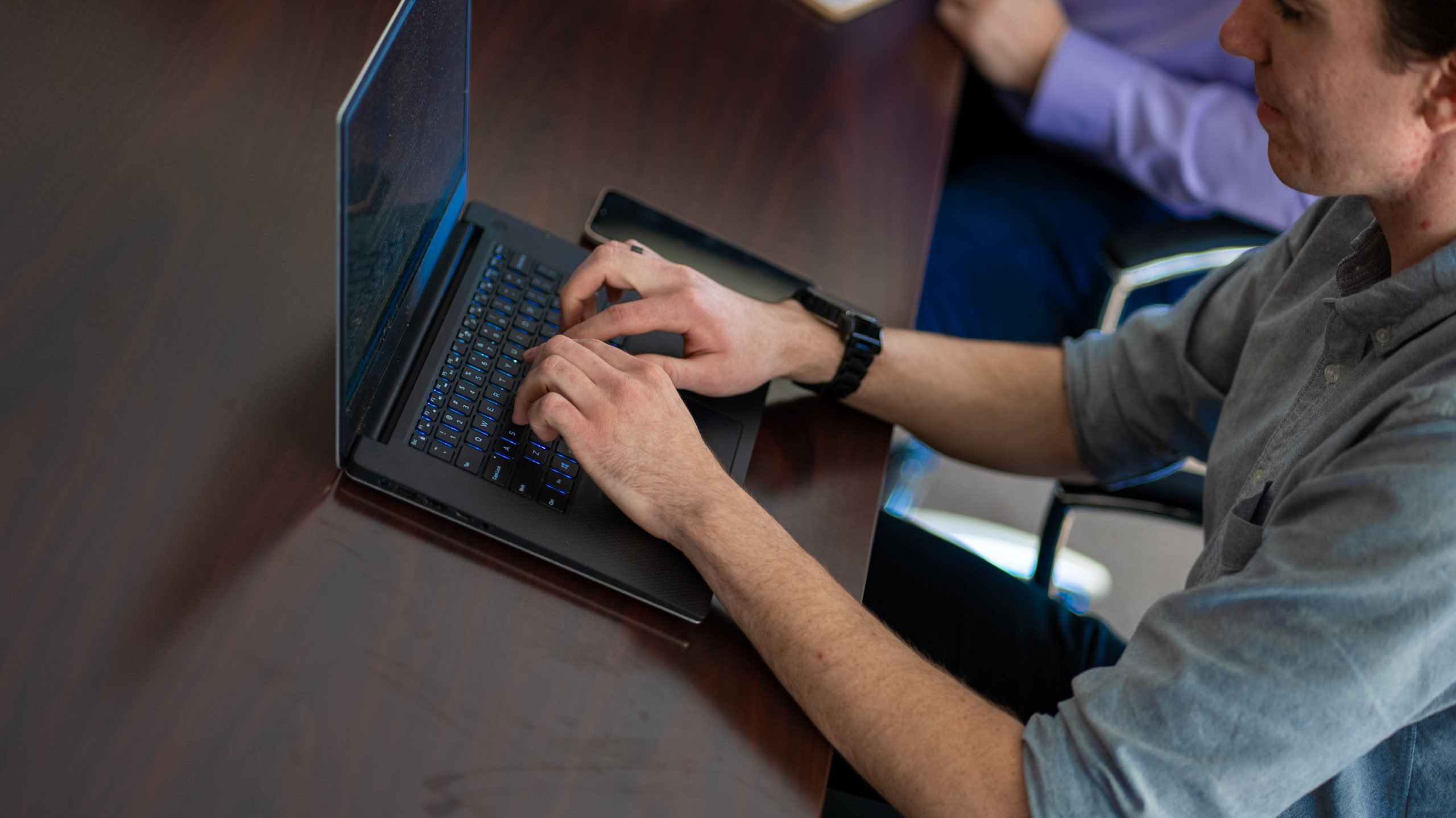 Gannett Peak team member working at a laptop